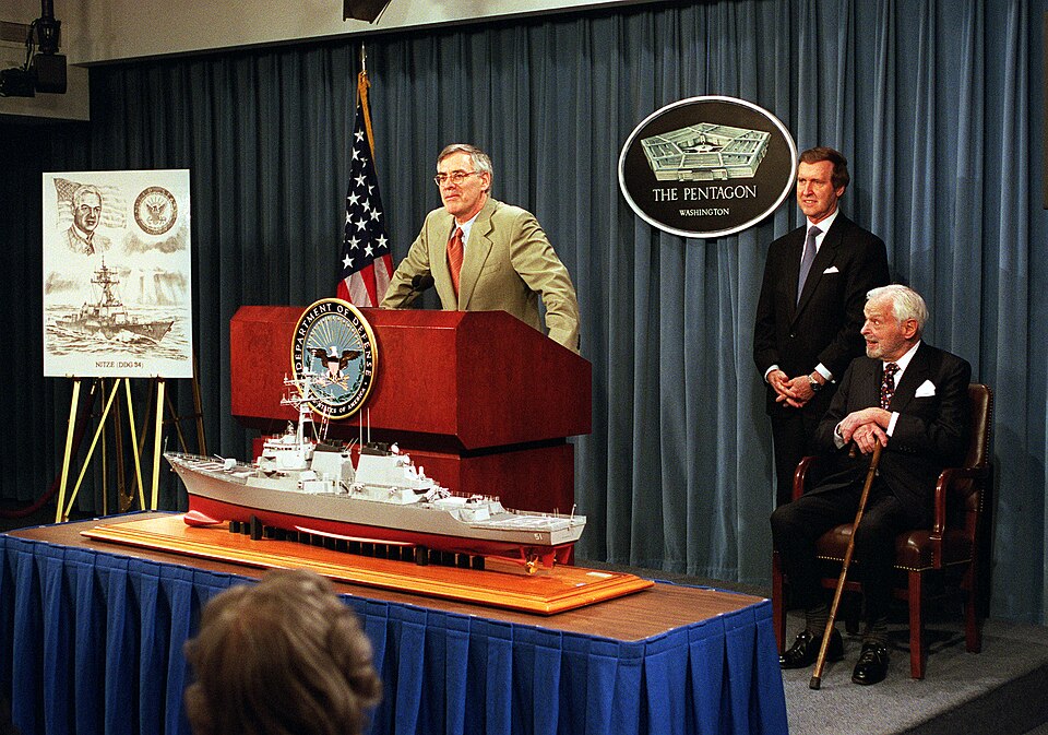 Secretary of the Navy Richard Danzig (left) announces at a Pentagon press conference on Jan. 10, 2001, that a new Arleigh Burke-class guided missile destroyer will be named in honor of famed defense policy and arms control expert Paul H. Nitze (seated right). Secretary of Defense William S. Cohen (c
