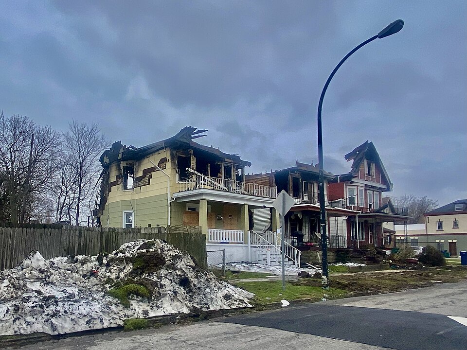 A trio of burned-out houses stand in ruins on the south side of Glenwood Avenue in Buffalo, New York, as seen on a January 2023 afternoon about two weeks after a historic blizzard that brought four feet of snow, hurricane-force winds, whiteout conditions, and 46 deaths to Buffalo and the surrounding