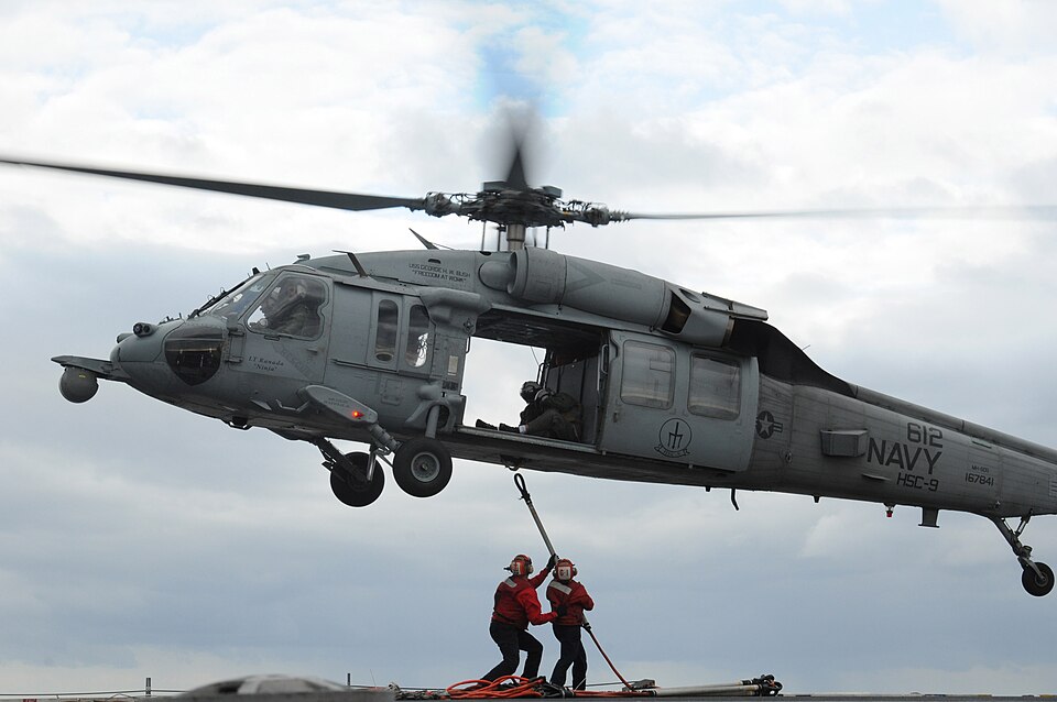 ATLANTIC OCEAN (Feb. 17, 2011) Sailors assigned to G-1 division of the weapons department of the aircraft carrier USS George H.W. Bush (CVN 77) attach pole pendants to an MH-60S Sea Hawk helicopter from Helicopter Sea Combat Squadron (HSC) 9 during a vertical replenishment with the aircraft carrier 