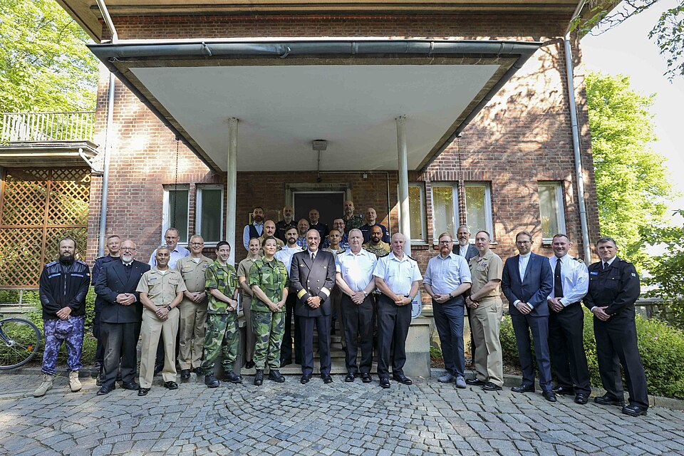 KIEL, Germany (June 17, 2023) Chaplains and religious affairs personnel from NATO Ally and partner nations pose for a photograph in front of a German military ministry building at the conclusion of exercise Baltic Operations 2023 (BALTOPS 23). Nineteen chaplains from 11 nations participated in BALTO