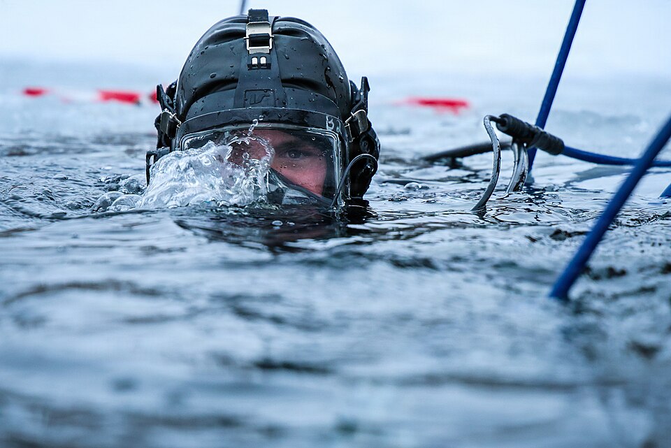 Equipment Operator 1st Class Devon Maher, U.S. Navy Seabee Diver assigned to Underwater Construction Team (UCT) One, Construction Dive Detachment Bravo (CDD/B), conduct ice diving operations during a bilateral ice diving exchange with Estonian Rescue Board and Estonian Navy divers at Rummu Quarry La