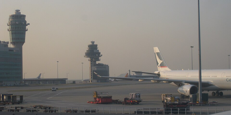 Hong Kong International Airport with a Cathay Pacific airplane nearby.