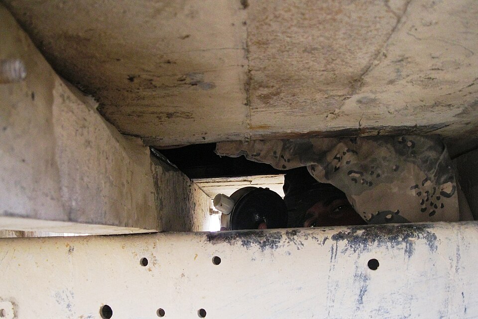 An Afghan Border Police member removes anti-personnel mines discovered in a hidden compartment during an inspection of a tractor-trailer combination vehicle at an ABP checkpoint near the Wesh border crossing point, Spin Boldak district, Kandahar province, Afghanistan, Dec. 18, 2012. More than 360 mi