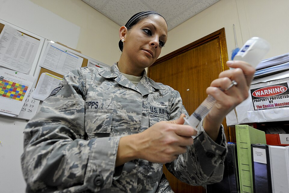 U.S. Air Force Senior Airman Kelly Tipps, 380th Expeditionary Medical Group diagnostic imaging journeyman, extracts medicine from a bottle prior to destroying it at an undisclosed location in Southwest Asia Oct. 16, 2013. Tipps who was a pharmacy technician prior to joining the military volunteers i