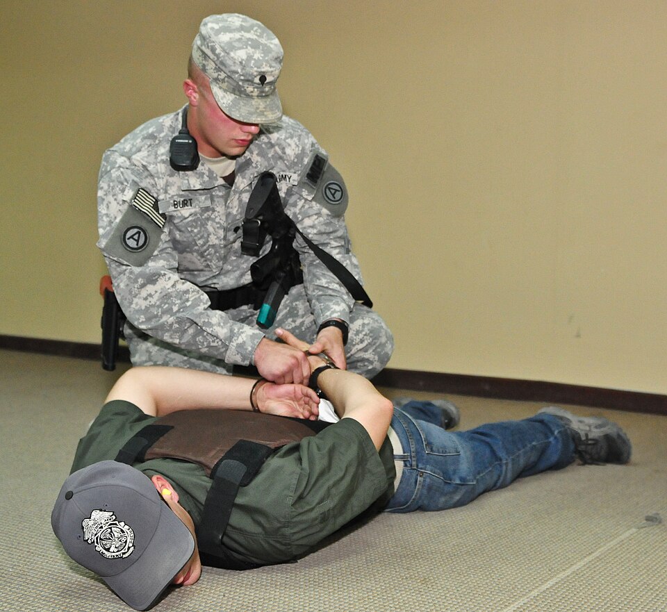 Spc. Aaron Burd, military police officer for Third Army/ARCENT, arrests a suspect during a MASCAL/Active shooter exercise on Camp Arifjan, Kuwait, Oct. 23, 2012. The exercise, which incorporated all emergency services on base, was intended to build confidence and understanding of real-life scenarios