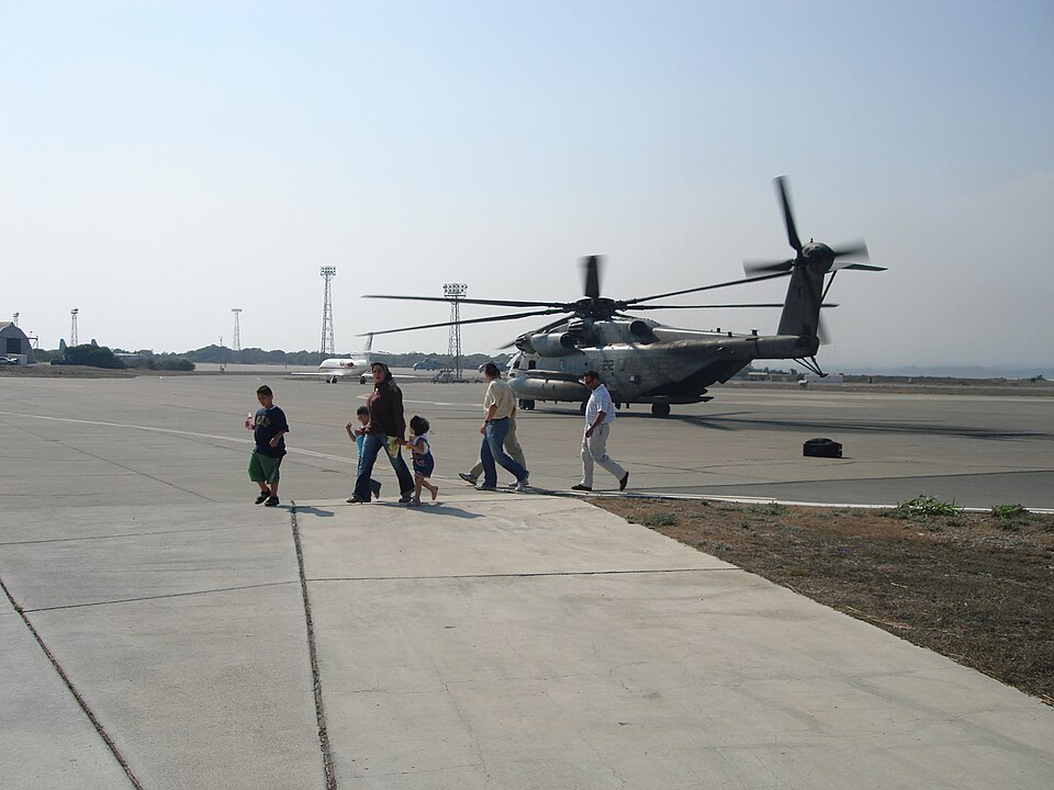 U.S. citizens exit a CH-53 transport helicopter in Cyprus following their departure from the U.S. embassy in Beirut, Lebanon. The 24th Marine Expeditionary Unit is assisting in the transport of American citizens wishing to leave Lebanon.