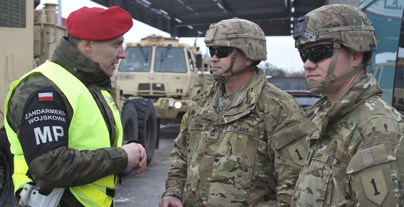 OLSZYNA, Poland (Feb. 5, 2019) - Members of the 1st Engineer Battalion, 1st Infantry Division out of Fort Riley, Kansas, communicate with the Polish military police during a vehicle inspection at checkpoint Oyszyna. The unit is convoying across eastern Europe as they prepare for their nine month rot