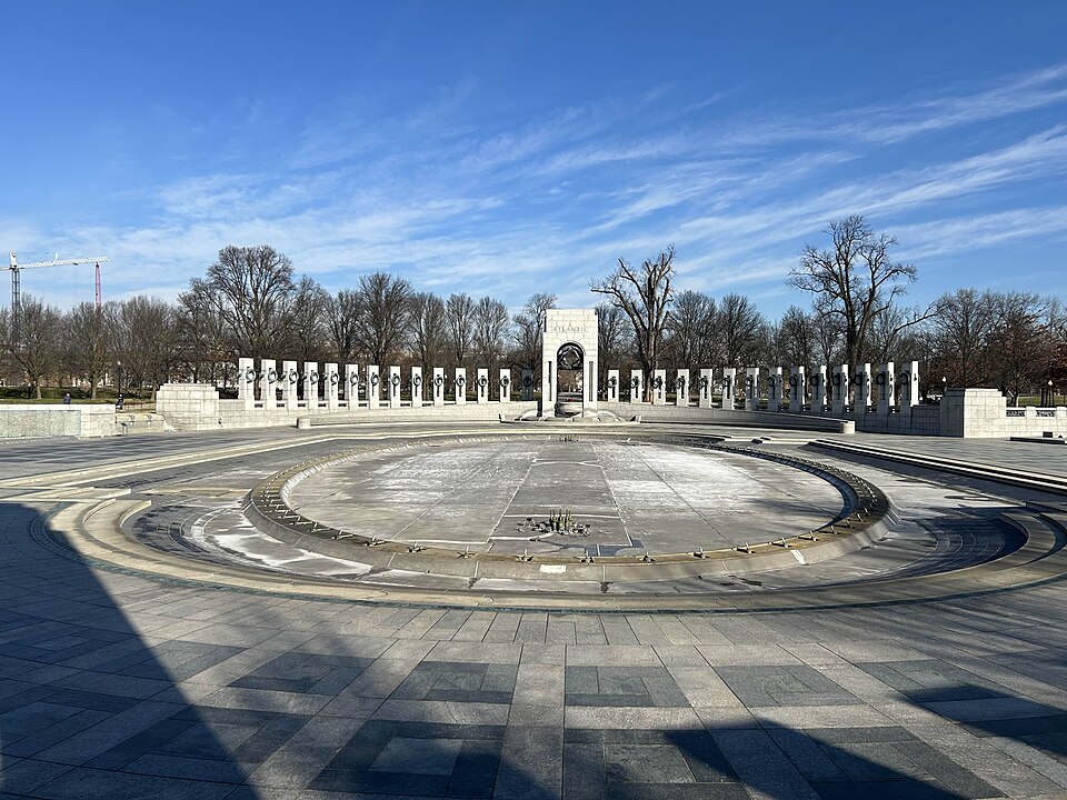 The National World War II Memorial in Washington DC, drained to allow for maintenance to its fountain. This photograph was taken from just in front of the Pacific arch, looking towards the Atlantic arch.