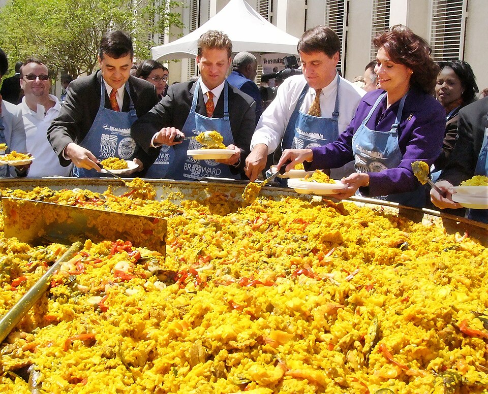 Paella is scooped from a giant pan in the Capitol courtyard and served to the public by House members during Dade-Broward Day activities Wednesday, April 6, 2005. From the left are Representatives: David Rivera, R-Miami; Carlos Lopez-Cantera; R-Miami; John Seiler, D-Pompano Beach; and Susan Goldstei