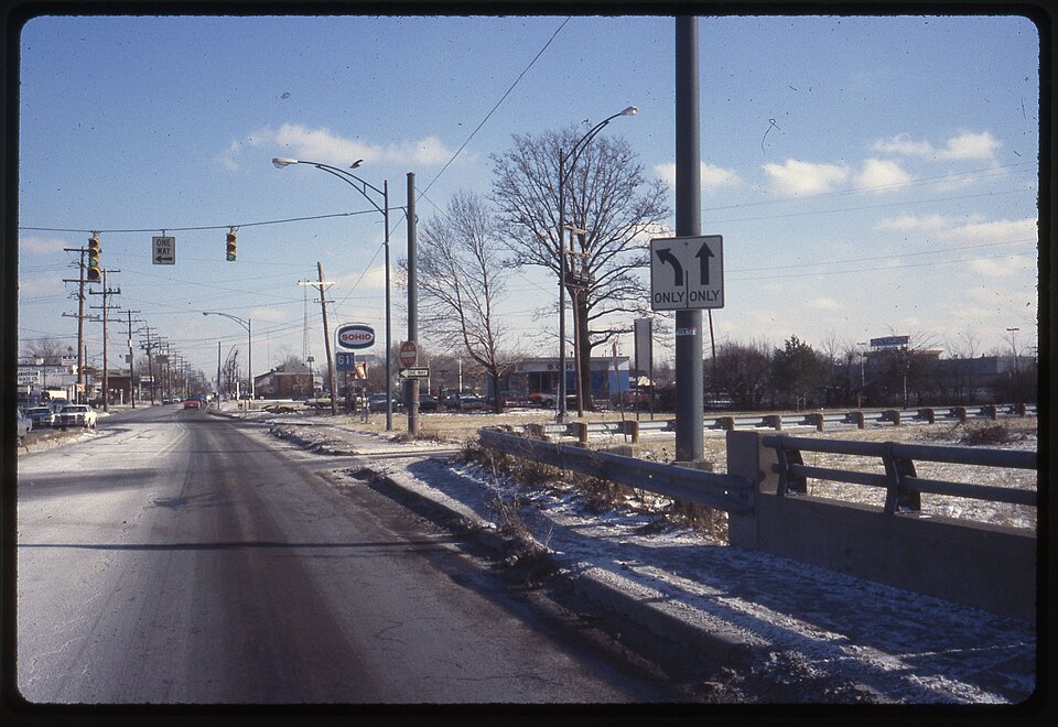 A view looking east on East Hudson Street toward the Sohio (Standard Oil of Ohio) service station on the right at 675 East Hudson Street. The price of gas at the self serve pumps was 61 9/10 cents per gallon. On the north side of Hudson Street can be seen signs for Anderson Glass Company, Key Laundr