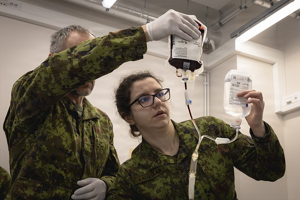Estonian 1st and 2nd Infantry Brigade Role 2 hospital personnel—comprised of active duty and reservists—perform a blood transfusion on a designated patient during a U.S.-led training event on March 25, 2026. The training consisted of a two-part course, beginning with classroom instruction followed b
