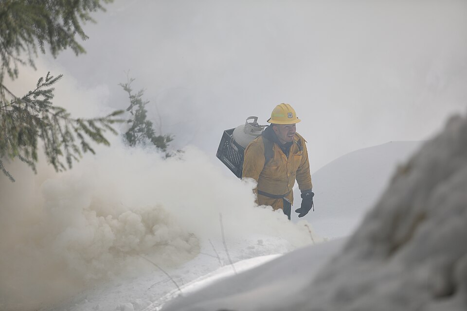 Esteban Avitia, firefighter type 2 with Big Bar Ranger District, ignites a pile of brush with a propane torch December 7, 2022. Forest Service fire personnel from the Shasta –Trinity National Forest conducted pile burning operations near Weaver Bally Fire lookout, north of Weaverville, CA. The area,