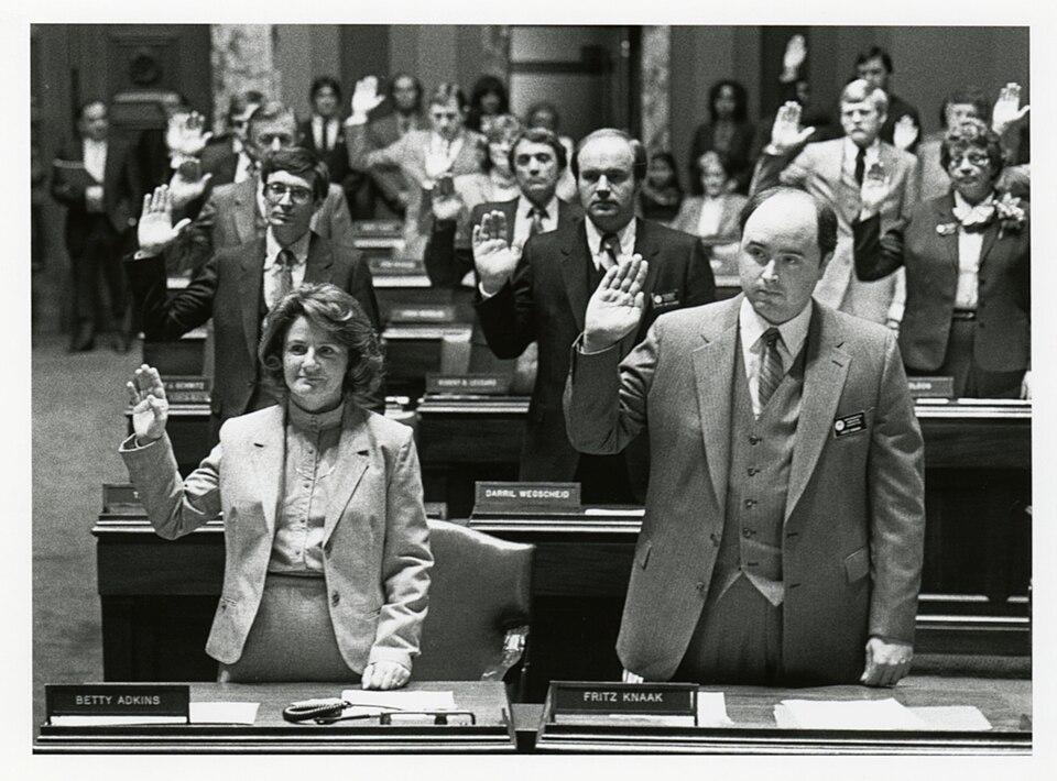 Swearing-in ceremony in the Senate Chamber during the opening day of the 1983 legislative session, St. Paul, Minnesota. For biographical information, see the Minnesota Legislative Reference Library database at: Adkins, Betty A.: http://www.leg.state.mn.us/legdb/fulldetail.aspx?id10008 ; Jude, Thadde