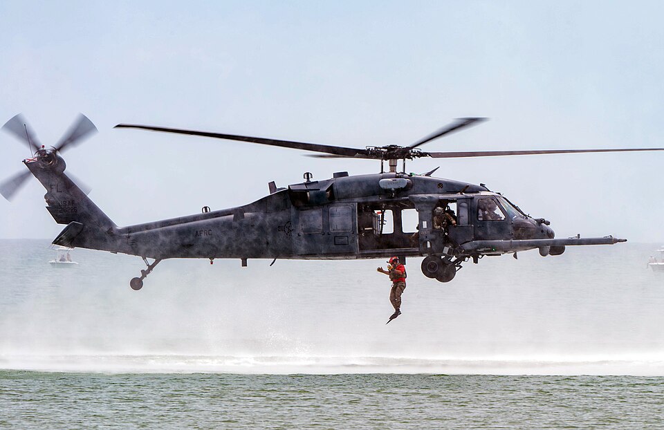 A Pararescueman, assigned to the 308th Rescue Squadron, jumps out of an HH-60G Pave Hawk helicopter during a simulated Combat Search and Rescue demonstration at the 2025 Cocoa Beach Air Show off the coast of Florida, July 13, 2025. The 920th RQW participates in air shows to demonstrate the wing's ab