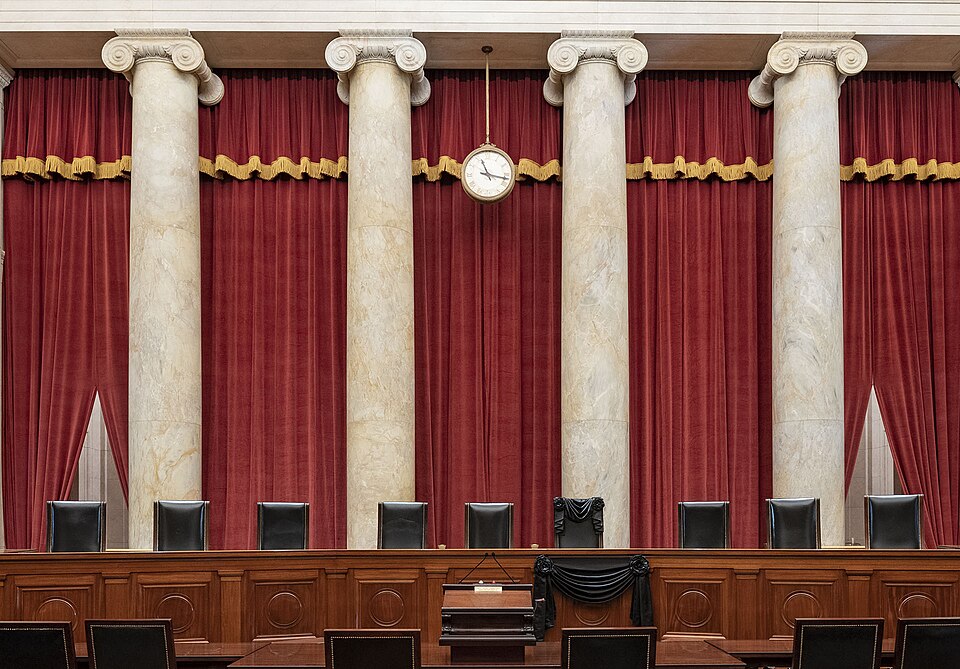 The Courtroom of the Supreme Court showing Associate Justice Ruth Bader Ginsburg’s Bench Chair and the Bench in front of her seat draped in black following her death on September 18, 2020.