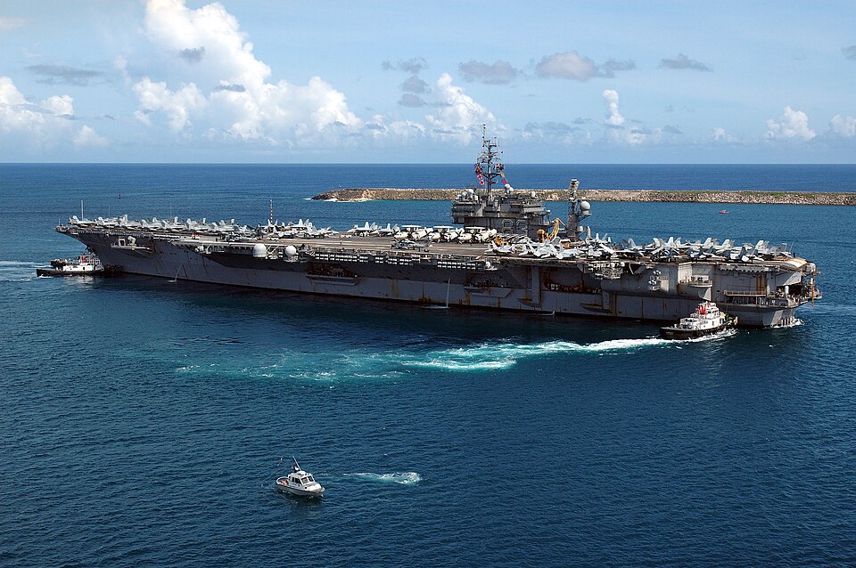 Apra Harbor, Guam (July 26, 2005) – The conventionally-powered aircraft carrier USS Kitty Hawk (CV 63) departs Naval Forces Marianas Support Activity, after a four-day port visit. Currently under way in the 7th Fleet area of responsibility (AOR), Kitty Hawk demonstrates power projection and sea cont