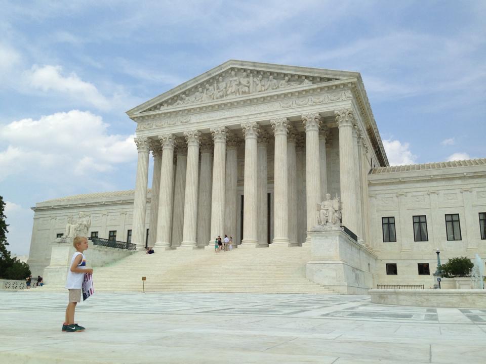 7 year old boy, a copy of the US Constitution in his hands, on the steps of the US Supreme Court