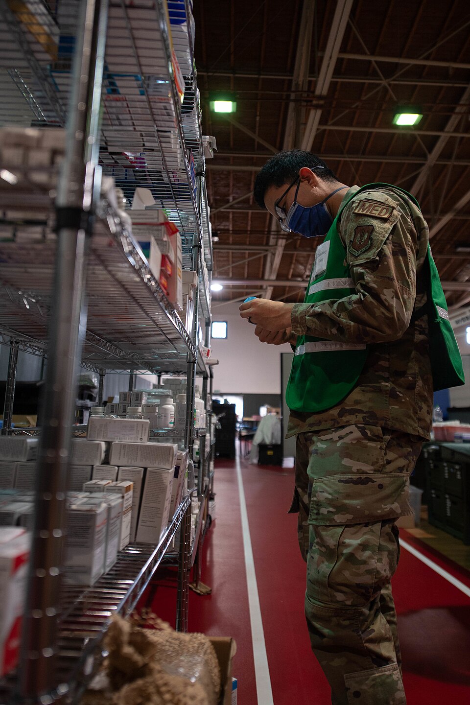 U.S. Air Force Amn Joel Madrigal, 86th Medical Support Squadron pharmacy technician, looks through the medication shelves at Ramstein Air Base, Germany, Sept. 9, 2021. Madrigal searched the shelves of a pharmacy located in a mobile field hospital set up to treat evacuees during Operation Allies Refu