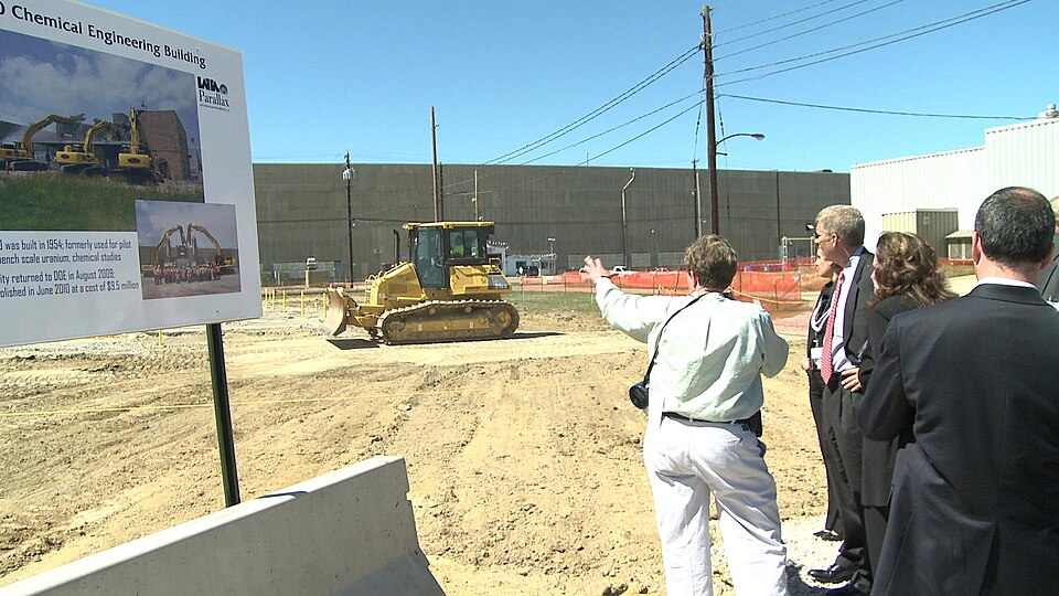 LATA/Parallax Portsmouth Project Manager Linda Bauer points out to Deputy Secretary Poneman the site where the X-760 Chemical Engineering Building once stood at the Portsmouth Site.  Demolition of the 8,000 square foot structure was completed in mid-June with $9.5 million in Recovery Act funding.