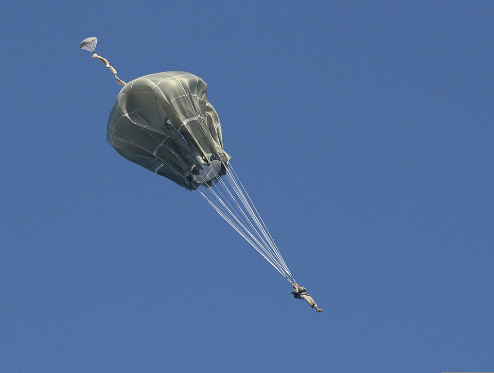 A U.S. Soldier assigned to the 173rd Infantry Brigade Combat Team conducts a training jump from a CH-47 Chinook helicopter into Bunker Drop Zone at the 7th Army Joint Multinational Training Command's Grafenwoehr Training Area in Grafenwoehr, Germany, Nov. 12, 2013, as part of Joint Multinational Rea