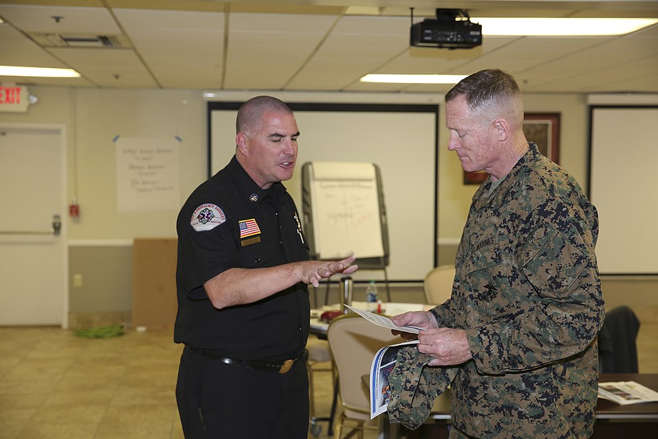 Greg Kunkel, Emergency Management Services Chief of Marine Corps Logistics Base Barstow (MCLBB), demonstrates a decontamination system to Brig. Gen. Edward D. Banta, Commanding General, Marine Corps Installations-West, at the MCLBB James L. Day Center, Mar. 9, 2016. Kunkel provided a detailed and ha