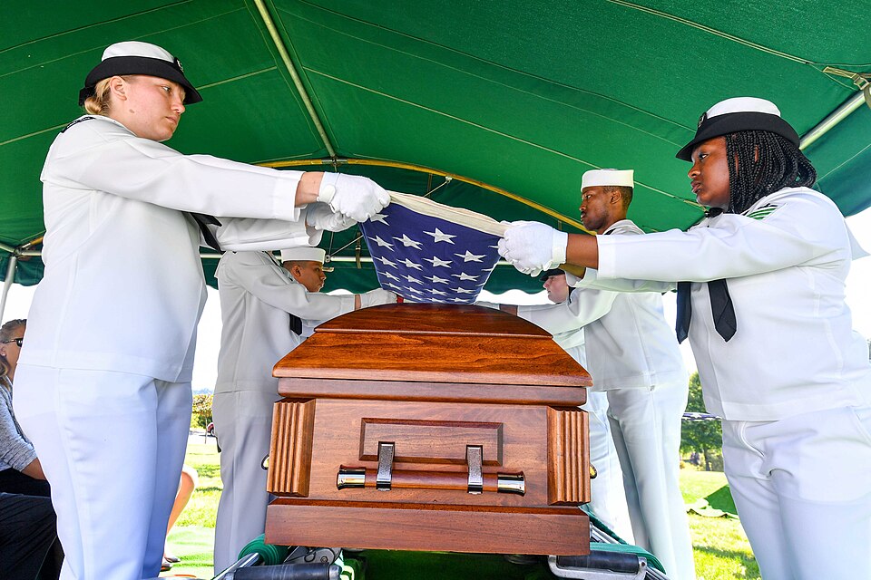 160829-N-EC099-133 BREMERTON, Wash. (Aug. 29, 2016) – Sailors assigned to Naval Base Kitsap fold the National Ensign over the remains of World War II  veteran Lt. Julian Jordan. Jordan was 37 years old when the attack on Pearl Harbor took place and he was indentified with the use of DNA profiling af