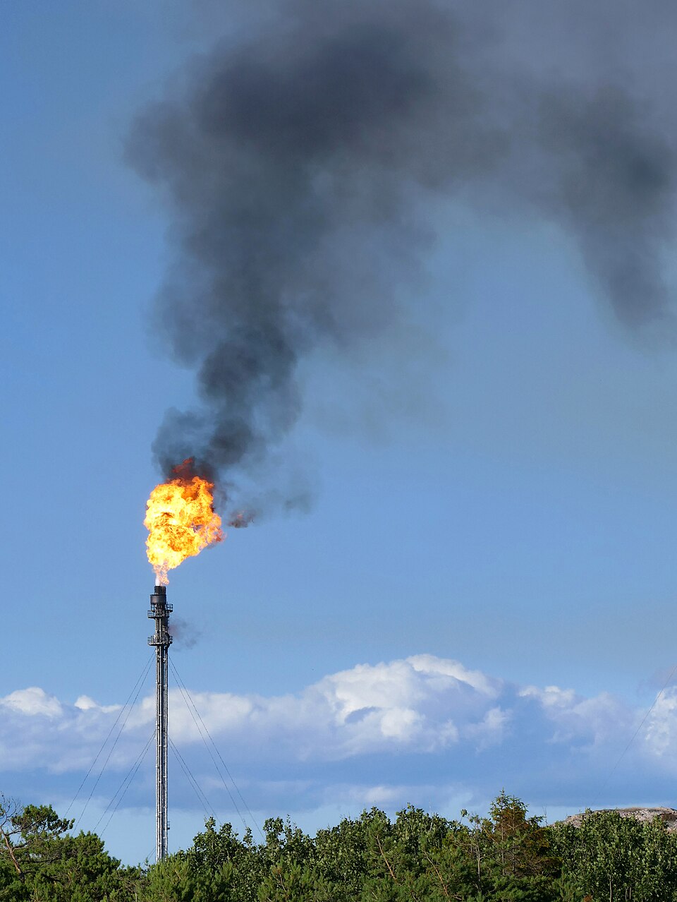 Gas flare on top of a flare stack at Preemraff oil refinery, Lysekil, Sweden. The flame is constantl