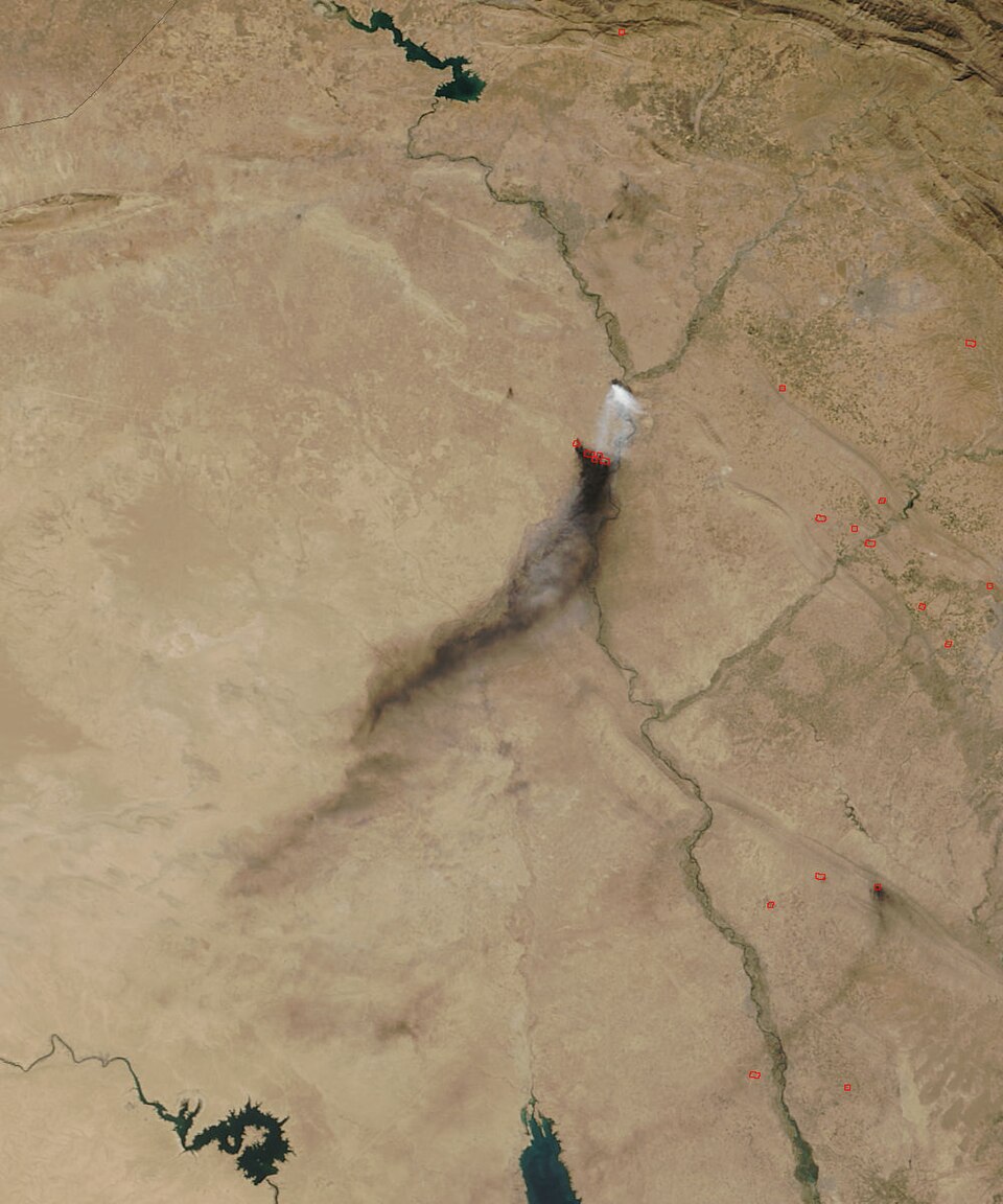 On October 21, 2016, the Moderate Resolution Imaging Spectroradiometer (MODIS) aboard NASA’s Terra satellite flew over Iraq and captured a true-color image of smoke and sulfur dioxide plumes pouring from fires burning south of Mosul.
The dark, oily-appearing plumes mark fires burning at the Qayyarah