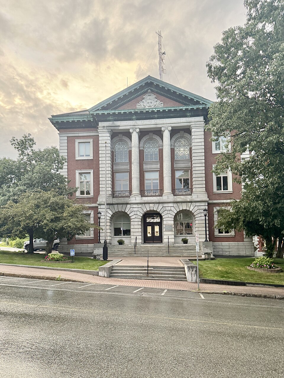 Built in 1902-1903, this Classical Revival-style building was designed by Wilfred E. Mansur to serve as the Penobscot County Courthouse, replacing a previous building on the same site.  The building is characterized by its red flemish bond brick exterior, hipped roof, rusticated stone pilasters and 