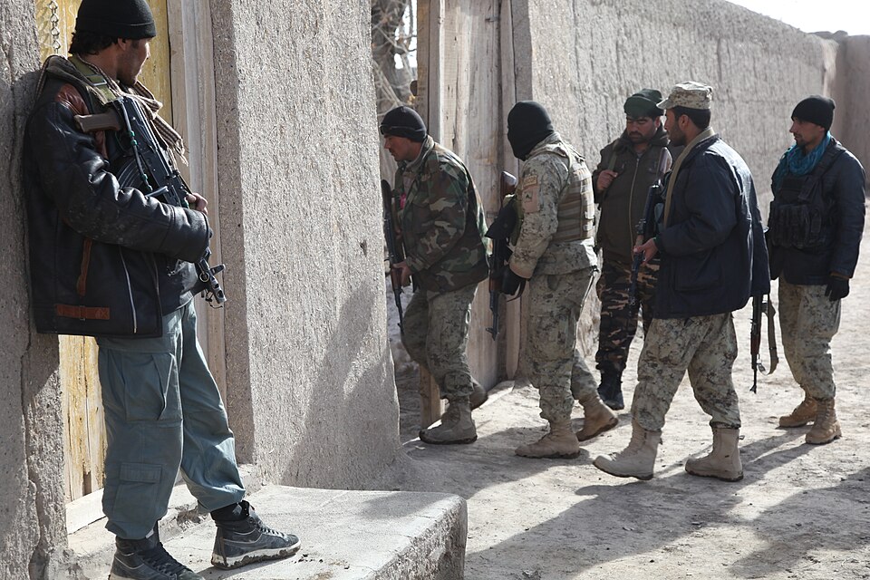 Afghan police officers enter a house while conducting a patrol in Kolagu, Paktia province, Afghanistan, March 9, 2012, during Operation Khoti Kheyl. The operation is designed to allow Afghan National Security Forces to show their presence throughout the province and demonstrate their strength and ca