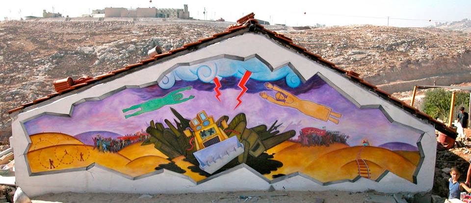 Mural at the Beit Arabiya Peace Center in Anata, East Jerusalem. The mural is dedicated to Rachel Corrie, an american killed with a bulldozer by Israeli forces while trying to prevent the destruction of Palestinian homes. 
Artist: Mike Alewitz. 2003.