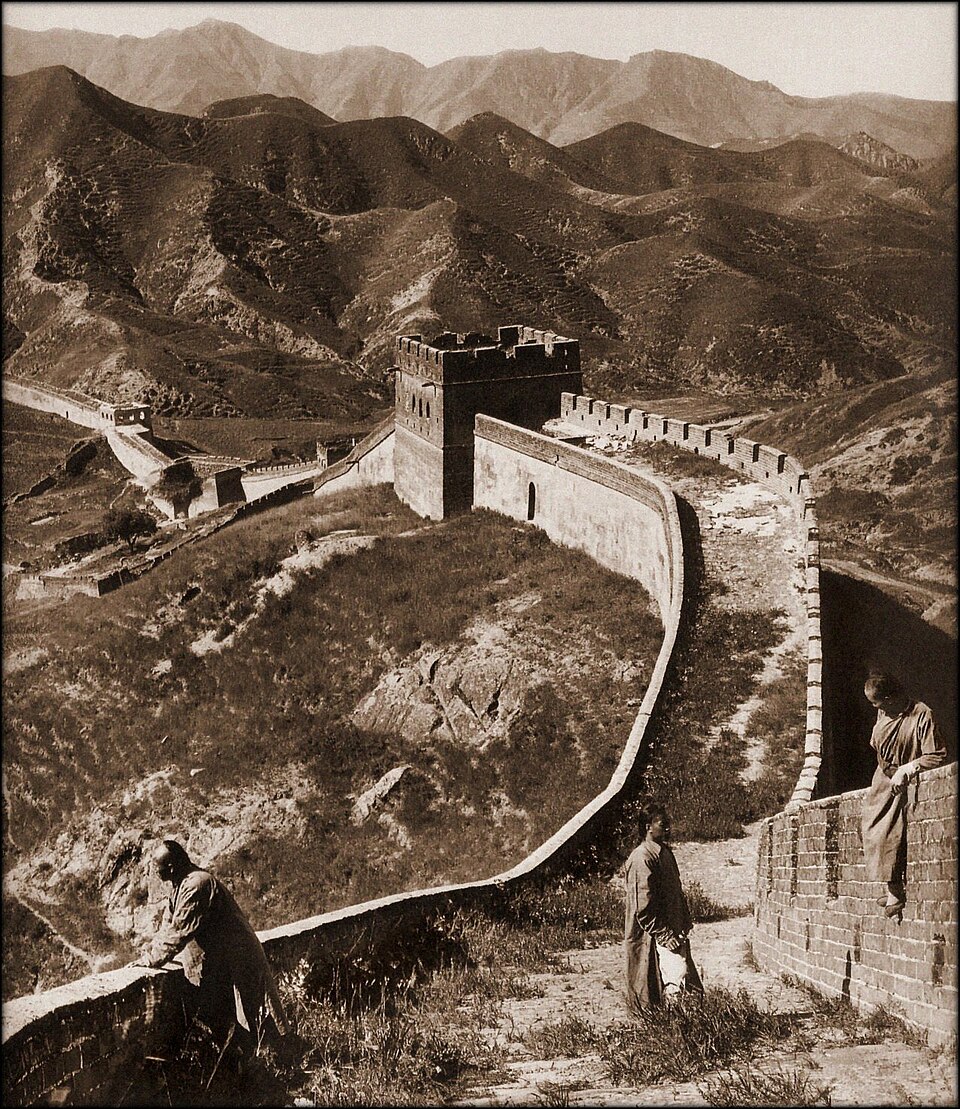 Entitled The Great Wall Of China [1907] H Ponting. [RESTORED] I repaired spots and small defects, adjusted contrast, tonality, and adding a sepia tone.
Ponting's placement of a person (or in this case, persons) somewhere in the foreground was a de rigueur photographic technique of the day. It was do