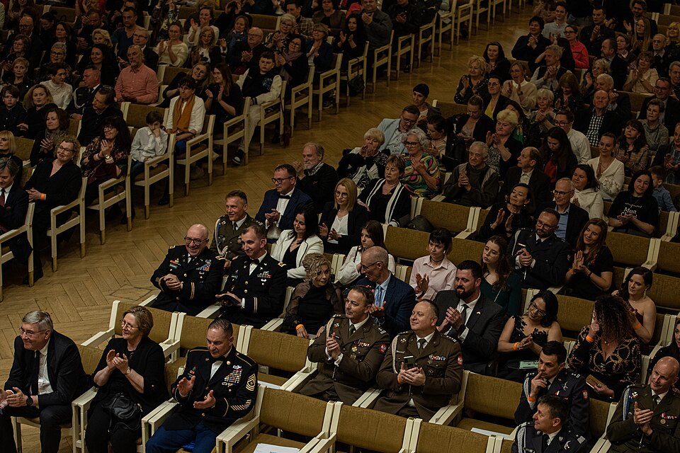An audience cheers for the Supreme Headquarters Allied Powers Europe International Band (SHAPE) during their performance at the Aula at Adam Mickiewicz University, Poznan, Poland, April 26, 2023. The SHAPE International Band’s mission is to promote and maintain the esprit de corps of SHAPE/NATO mili