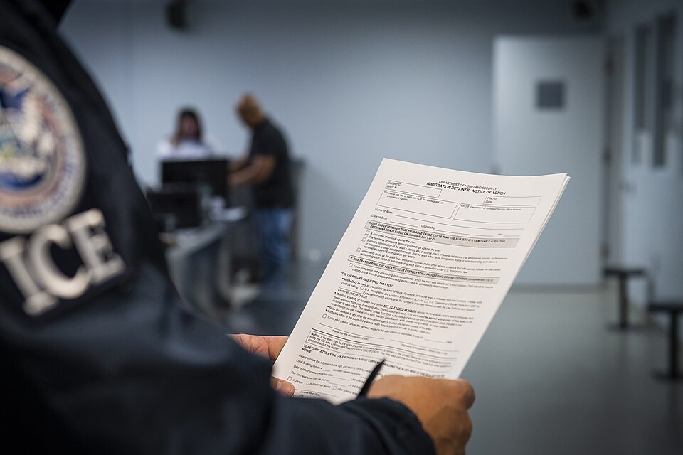 Photos of an Immigration Detainer form taken at a detention facility.
