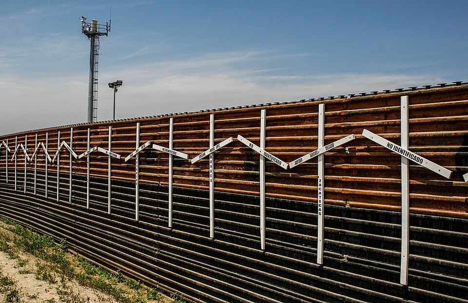 Mexico–United States barrier at the border of Tijuana, Mexico and San Diego, USA. The crosses represent migrants who died in the crossing attempt. Some identified, some not. Surveillance tower in the background.