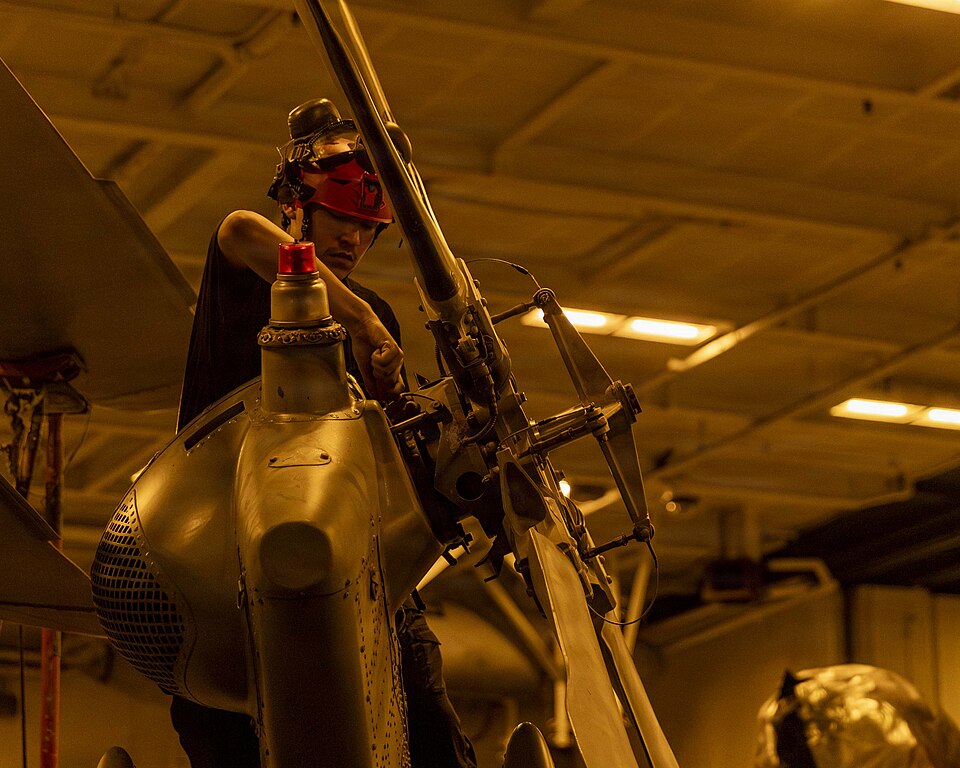 A U.S. Sailor conducts maintenance on an MH-60R Sea Hawk, attached to Helicopter Maritime Strike Squadron (HSM) 71, in the hangar bay of Nimitz-class aircraft carrier USS Abraham Lincoln (CVN 72), May 26, 2026. Abraham Lincoln is deployed to the U.S. 5th Fleet area of operations to support maritime 
