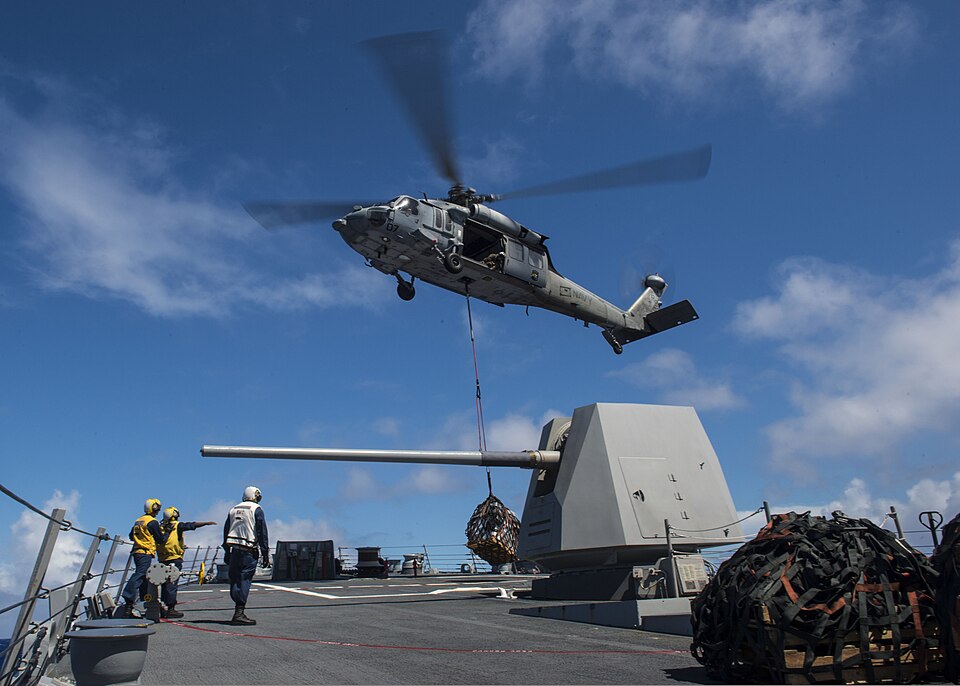 A U.S. Navy SH-60B Seahawk helicopter assigned to Helicopter Combat Support Squadron (HSC) 25 delivers cargo to the guided missile destroyer USS Preble (DDG 88) during a replenishment at sea in the Pacific Ocean Aug. 19, 2013. The Preble was part of the George Washington Carrier Strike Group and was