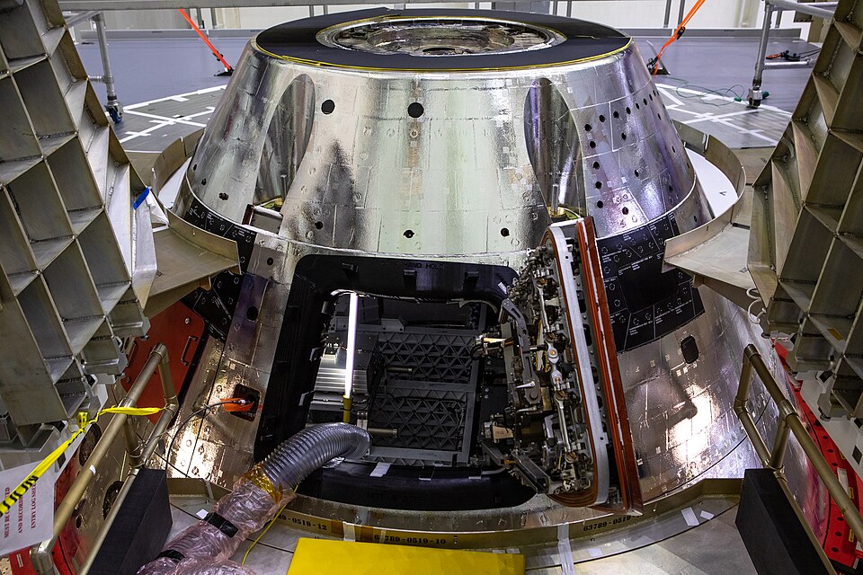 The forward bay cover is installed on the Artemis I spacecraft in the Final Assembly and System Testing (FAST) cell inside the Neil Armstrong Operations and Checkout building high bay at NASA’s Kennedy Space Center in Florida on Nov. 23, 2020. It protects the upper part of Orion during the mission a