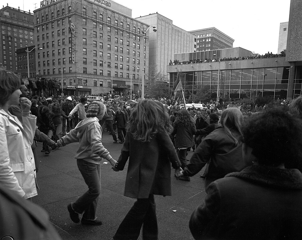 Anti-war protest, organized by People's Coalition for Peace and Justice, Downtown, Seattle, Washington, 1971. This is on the plaza in front of what was then the Seafirst Tower and is now (2024) Safeco Plaza. In the middle ground at right is the main branch of the Seattle Public Library. Designed by 