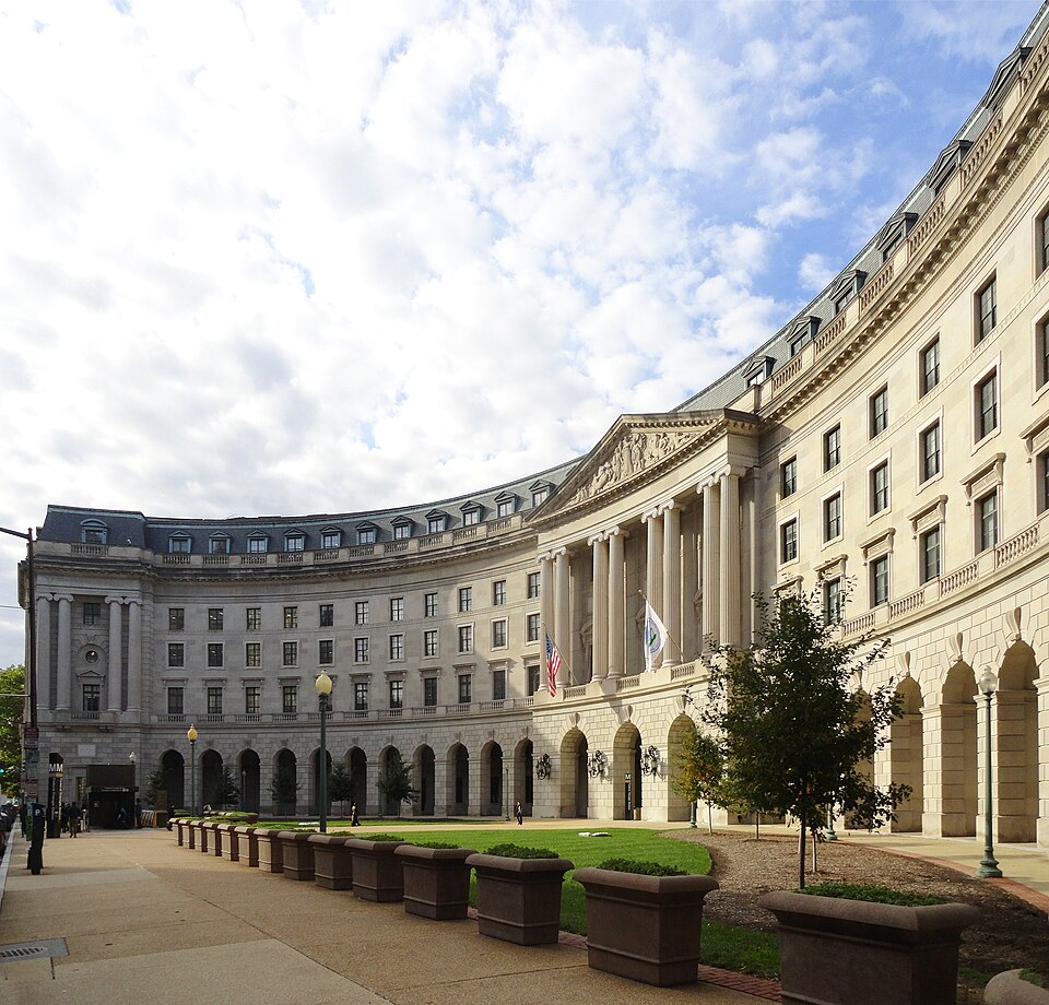 Main entrance of U.S. EPA Headquarters; the William Jefferson Clinton Federal Building on 12th Street, N.W., Washington, D.C. The pylon and elevator entrance for the Federal Triangle Metro station is seen on the left.