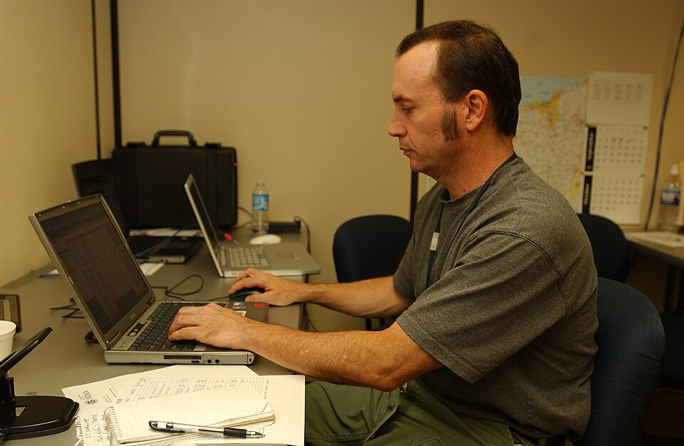 Findlay, Ohio  September 4, 2007 --   FEMA photographer Mark Wolfe working on a computer testing transmission lines at the Joint Field Office (JFO).  During a disaster FEMA brings in photographers to document response and recovery efforts.  John Ficara/FEMA
