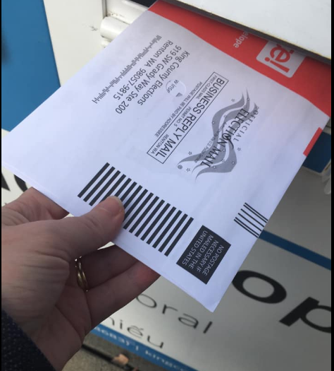 Washington voters vote by postage paid mail or at a drop box.