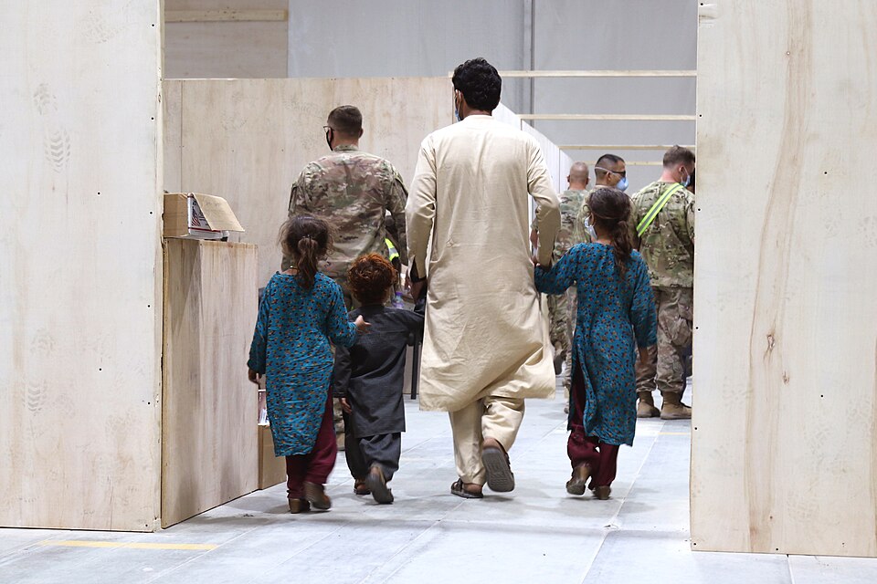 An Afghan family walks toward a medical screening station while in-processing at Camp Buehring, Kuwait. 
Although the operation is State Department-led, the Department of Defense has been tasked with assisting with providing transportation, security, logistics and medical support for Special Immigra