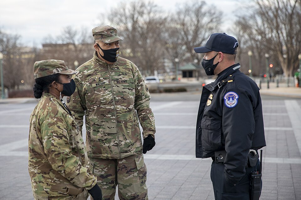 U.S. Army Maj. Gen. William J. Walker, commanding general, District of Columbia National Guard, and Brig. Gen. Janeen L. Birckhead, D.C. National Guard task force commander, speaks with a Capitol Police officer near the U.S. Capitol in Washington, D.C. Jan. 29, 2021. The National Guard has been requ
