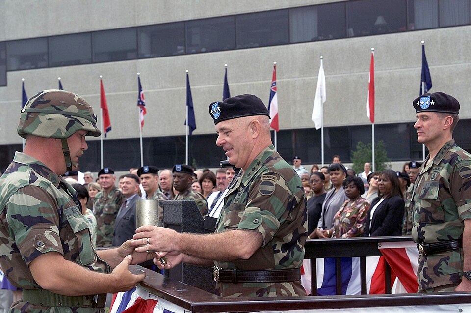 Lieutenant General (LGEN) Leon J. LaPorte, USA, Deputy Commanding General US Army Forces Command, accepts a shell casing from a US Army Military Police (MP) Honor Guard member during the Retirement Ceremony for Lieutenant General (LGEN) Lawson W. Magruder III USA, Deputy Commanding General and Chief