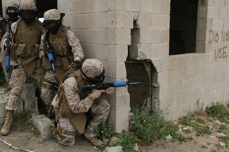 Marines with Military Police Company, Combat Logistics Regiment 17, 1st Marine Logistics Group, post security near a building during a field training exercise for their upcoming deployment to Afghanistan at the 25 Area Military Operations on Urban Terrain town April 23 and 24. Marines trained throug