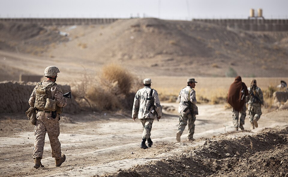 U.S. Marine Staff Sgt. Timothy Easterly, a member of the Border Advisor Team 2 in support of 1st Light Armored Reconnaissance Battalion, and members of the Afghan Border Police return to Patrol Base Pay Banadar during a partnered security patrol here, Jan. 30. In southern Garmsir district, an area w