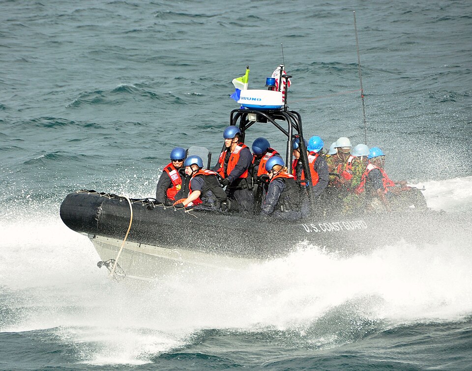 Members of a visit, board, search and seizure team assigned to the U.S. Coast Guard cutter Mohawk, and a law enforcement detachment made up of members of the Sierra Leone Armed Forces, make their way toward Mohawk on an rigid-hull inflatable boat after conducting a search of two vessels suspected of