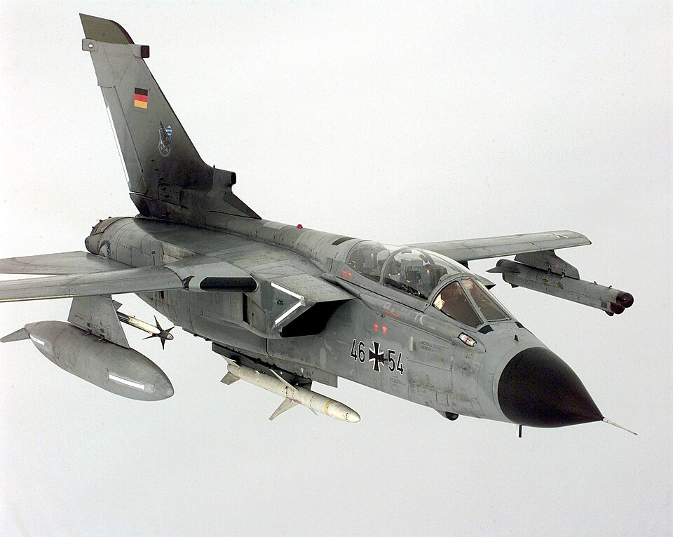 A Luftwaffe (German Air Force) Panavia Tornado ECR (s/n 46+54) of JaboG 32, Lechfeld (Germany), armed with an AIM-9 Sidewinder air-to-air missile and a jamming pod attached to the wings, and an AGM-88 HARM air-to-ground missile attached to the underside of the fuselage heads back towards its patrol 