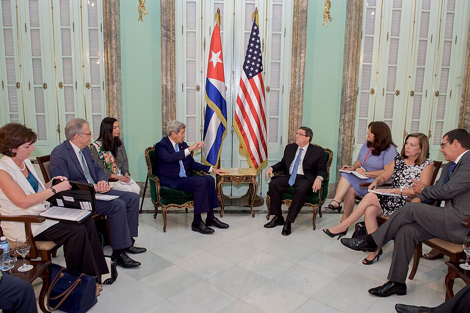 U.S. Secretary of State John Kerry and the U.S. delegation -- Ambassador Jeffrey DeLaurentis, Chargé d'Affaires at U.S. Embassy Havana, and Assistant Secretary of State for Western Hemisphere Affairs Roberta Jacobson -- chat with Cuban Foreign Minister Bruno Rodríguez and the Cuban delegation before